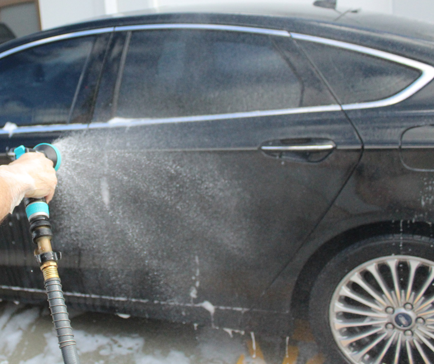 we will rinse off the entirety of the car and make sure there are no more suds or car shampoo on the surface.